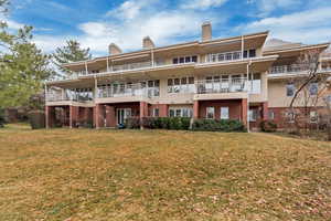 Rear view of property featuring a lawn