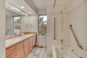 Bathroom with vanity and tiled shower / bath combo