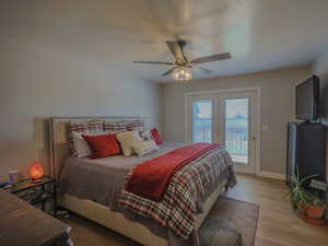 Bedroom featuring ceiling fan, light hardwood / wood-style flooring, and access to outside