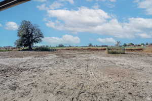 View of yard with a rural view