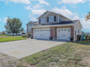 View of home's exterior with a garage and a yard