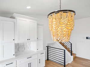 Interior space with hardwood / wood-style floors and a notable chandelier