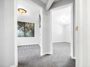 Corridor with carpet floors and a textured ceiling