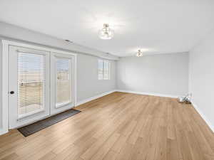 Unfurnished room with light hardwood / wood-style flooring