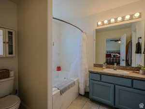 Full bathroom featuring tile patterned flooring, vanity, shower / bath combination with curtain, and toilet