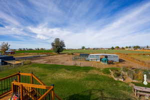 View of yard with an outbuilding and a rural view