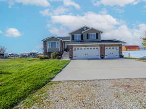 View of front of home featuring a garage and a front lawn