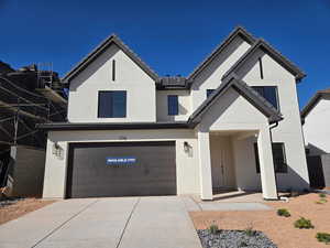 View of front facade featuring a garage