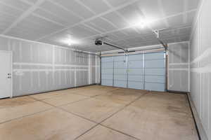 Garage featuring a garage door opener