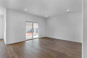 Empty room with dark hardwood / wood-style flooring