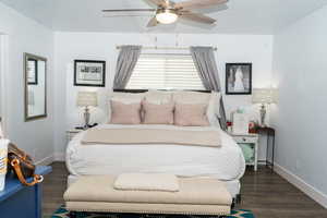 Bedroom with dark hardwood / wood-style floors and ceiling fan