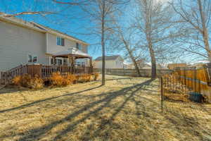 View of yard with a wooden deck and a gazebo