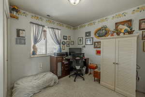 Bedroom featuring light colored carpet