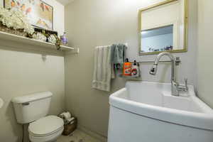 Bathroom featuring sink, tile patterned floors, and toilet