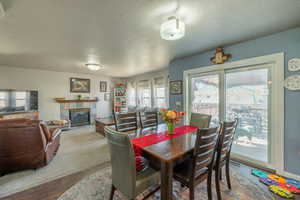 Dining area featuring hardwood / wood-style flooring, a tile fireplace