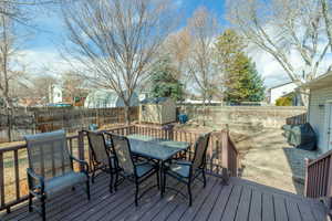 Deck featuring grilling area, a storage unit, and a patio area