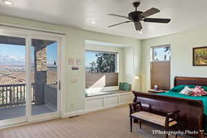 Bedroom with ceiling fan, a textured ceiling, light carpet, and access to outside