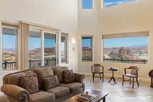 Living room featuring a mountain view, a towering ceiling, and light tile patterned floors