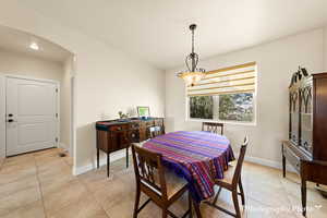 Dining space featuring light tile patterned flooring