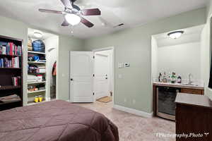 Bedroom with wet bar, wine cooler, and ceiling fan