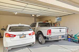 Garage featuring a garage door opener and a carport