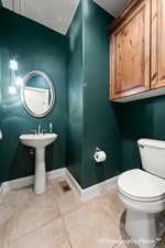 Bathroom with tile patterned floors and toilet