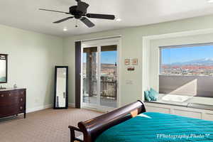 Carpeted bedroom with access to exterior and ceiling fan