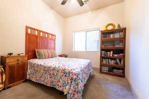 Carpeted bedroom featuring ceiling fan