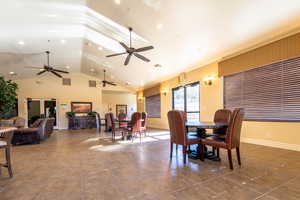 Dining space featuring high vaulted ceiling and tile patterned flooring