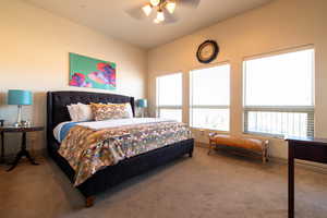 Carpeted bedroom featuring ceiling fan