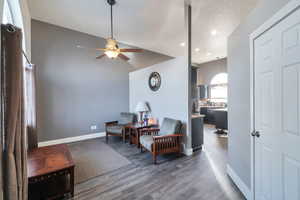 Sitting room with dark hardwood / wood-style flooring, ceiling fan, and a textured ceiling