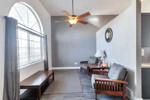 Sitting room featuring ceiling fan and dark hardwood / wood-style flooring