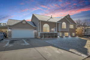 View of front of property with a garage and a porch