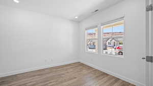 Unfurnished room featuring light wood-type flooring