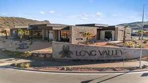 Community / neighborhood sign with a mountain view