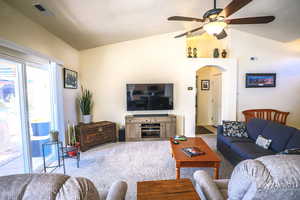 Living room with lofted ceiling and ceiling fan