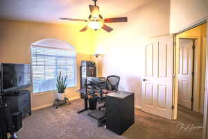 Carpeted home office with ceiling fan