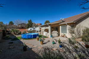 View of swimming pool with area for grilling