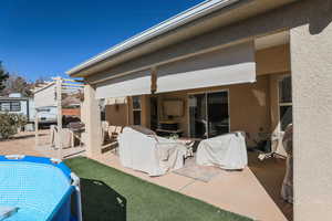 Rear view of house featuring a pergola and a patio