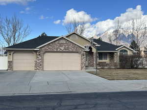 Ranch-style house featuring a garage and a mountain view