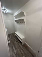 Mudroom featuring dark hardwood / wood-style flooring and a textured ceiling