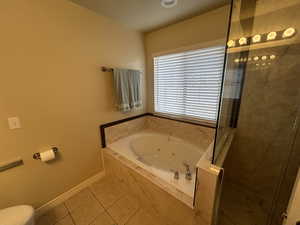 Bathroom featuring tile patterned flooring and plus walk in shower