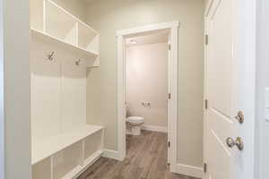 Mudroom featuring baseboards, visible vents, and dark wood-type flooring