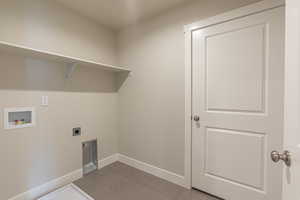 Clothes washing area featuring laundry area, hookup for a washing machine, baseboards, and hookup for an electric dryer