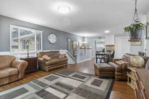 Living room featuring dark hardwood / wood-style floors and a notable chandelier