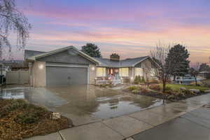 Single story home with a porch and a garage