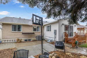 Back of property featuring central AC unit and a patio