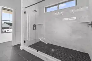 Bathroom with tile patterned floors and an enclosed shower