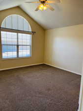 Guest bedroom featuring ceiling fan, lofted ceiling, and carpet flooring