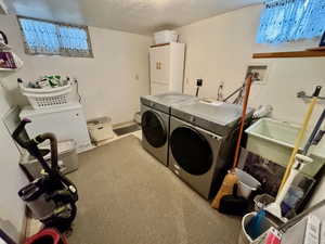 Laundry room featuring washer and clothes dryer